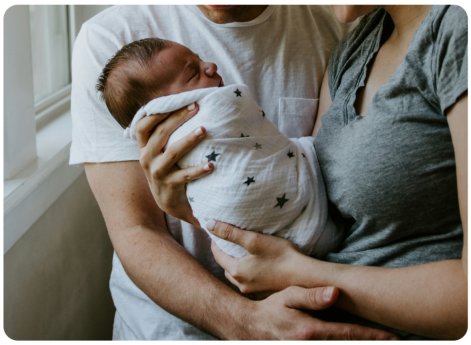 Family holding a baby